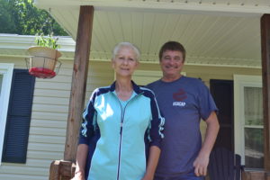 Peggy Wolford of Leander stands on her porch with Big Sandy Area Community Action Program Weatherization Assistance Program Inspector Steve Mullins. Mullins and the BSACAP added insulation to Wolford’s home free of charge in order to help her manage her winter heating bills.
