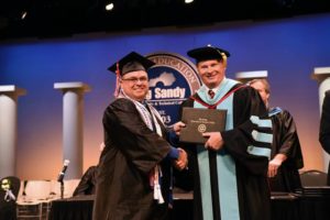 Greg Castle of Staffordsville, left, shakes hands with Dr. Devin Stephenson of Big Sandy Community and Technical College upon receiving his electrical degree. Castle graduated in May with the help of the Hiring Our Miners Everyday program after being laid off from the coal industry.