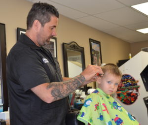 Michael Lowe was laid off from his work as a coal miner but is now working as a barber at Goodfellas Barbershop on Division Street in Pikeville after taking advantage of the educational opportunities provided by the Hiring Our Miners Everyday Program and Big Sandy Area Community Action Program.